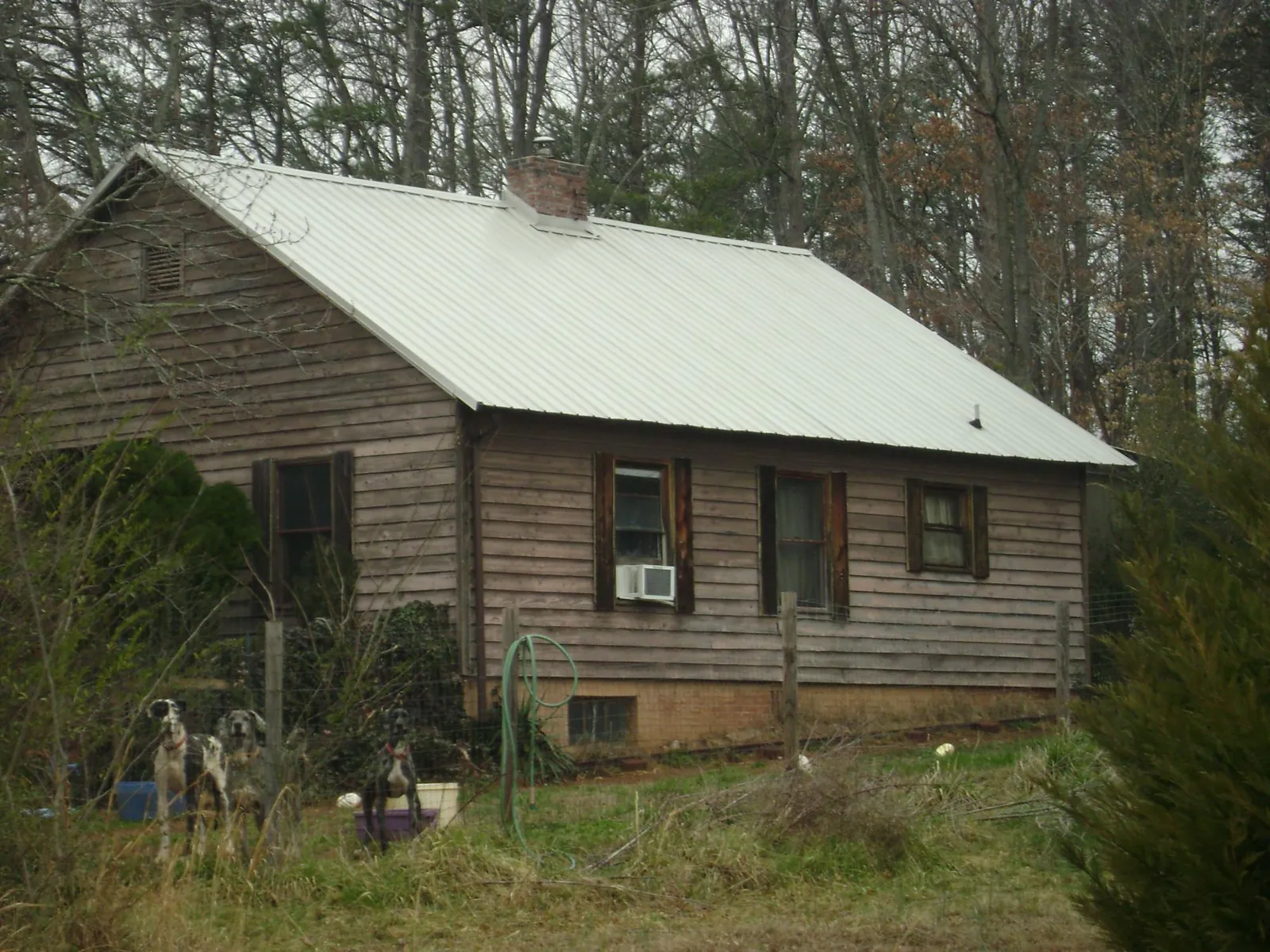 White metal roof on an old wood sided farmhouse, from a Metal Roof Installation job in Millheim